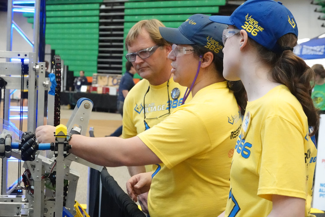 Voltage students demoing robots at a FIRST event