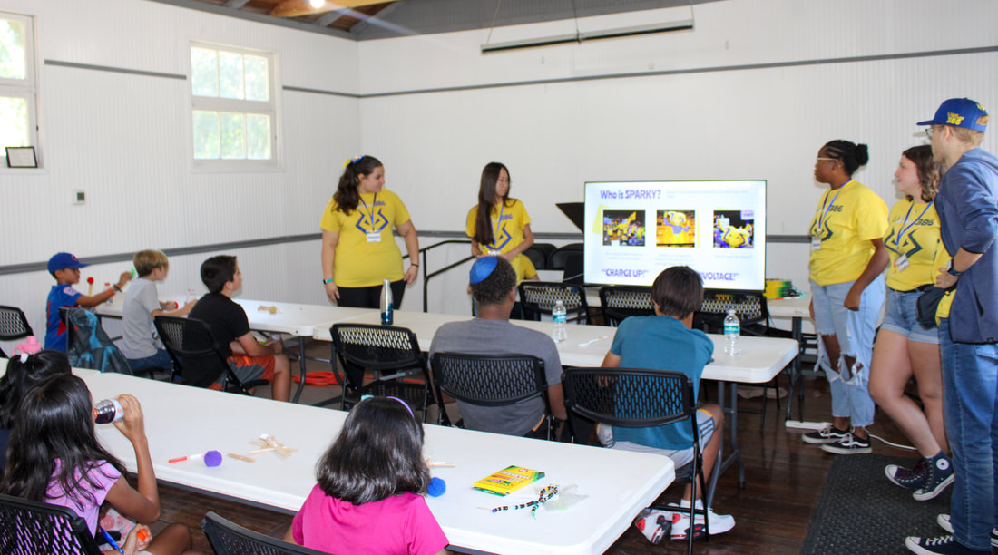 Campers making binary bracelets