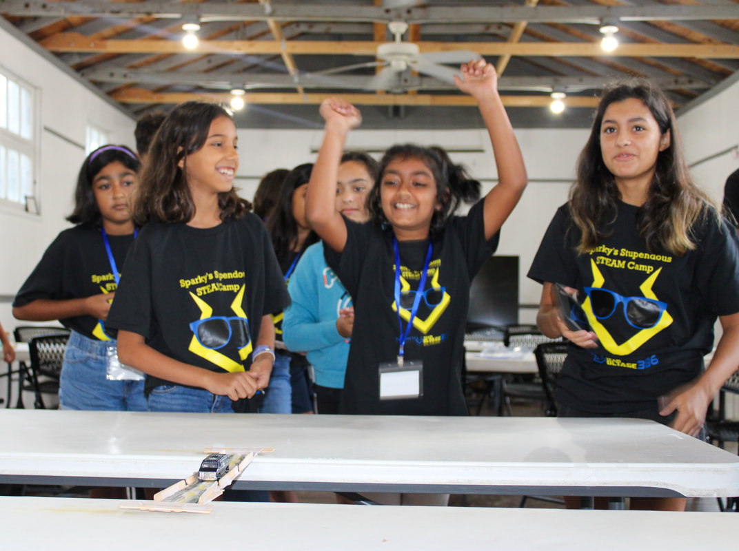 Mentor helping camper with circuits